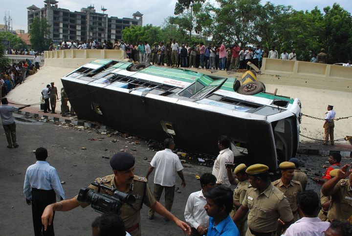 Bus Overturns After Hitting Divider