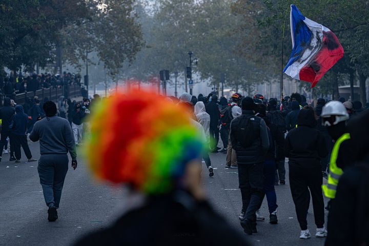 Paris Couple Calmly Drinks Amid Protest Fires – Viral Moment